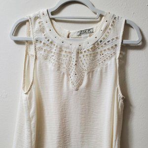 Chloe K women's cream sleeveless blouse with embroidered design on front top.